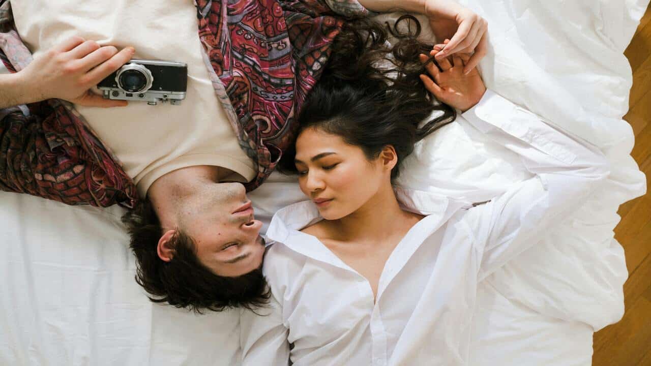 A couple lying in in bed 