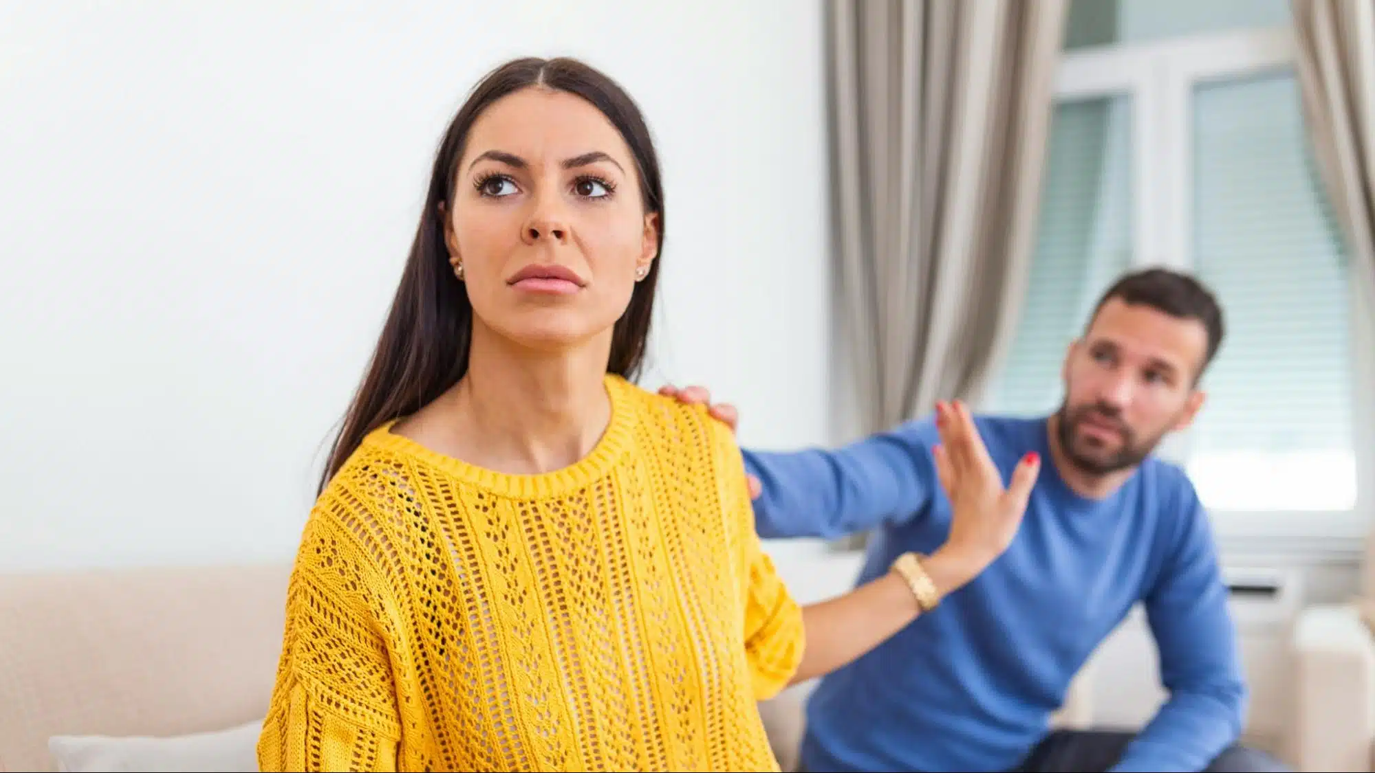 A man trying to say sorry to woman