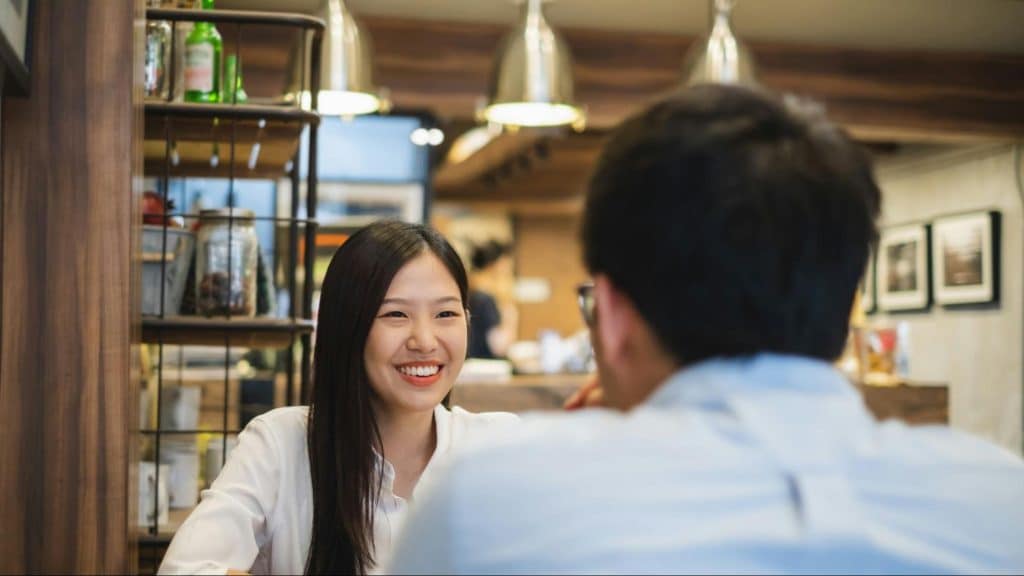 Woman smiling to a man