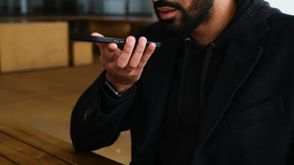 A person speaking into a smartphone.