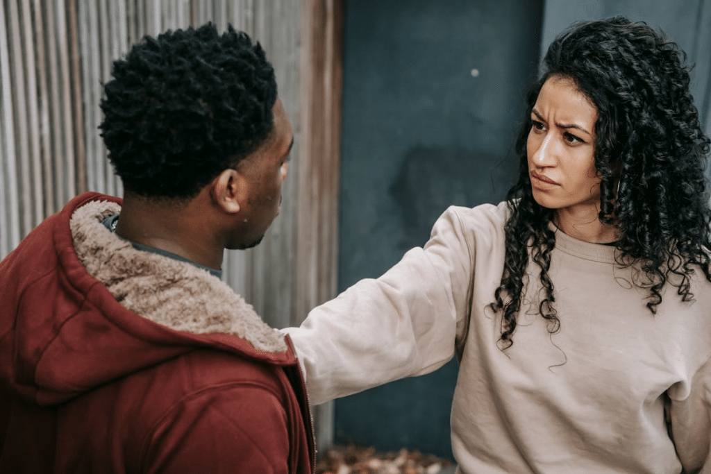 Unhappy multiethnic couple on street