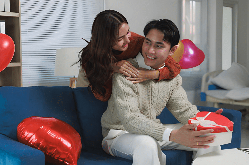 Wife giving husband heart shaped gift