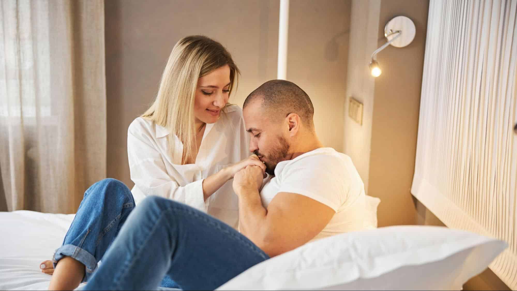 A man kissing woman’s hand