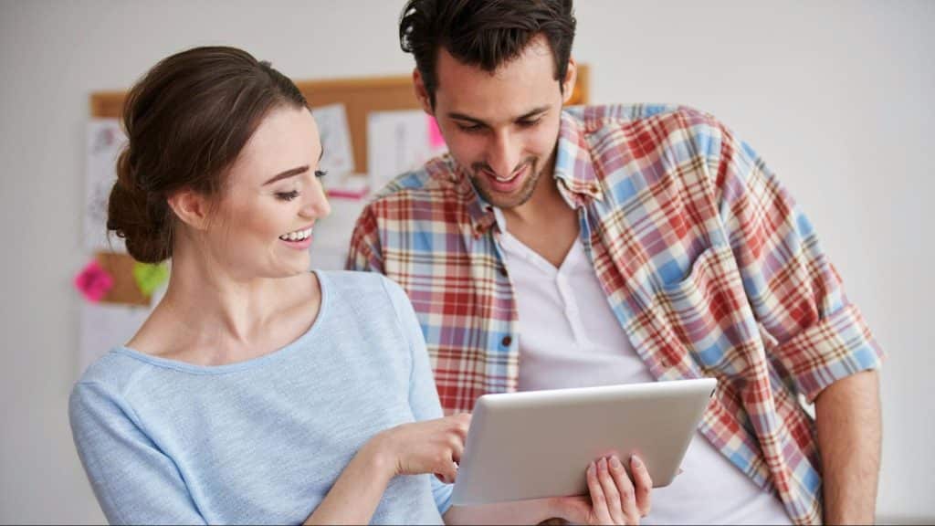A man and woman checking something