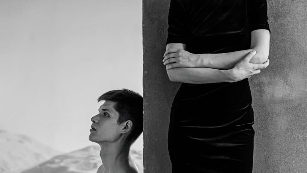 A person leaning against a wall.