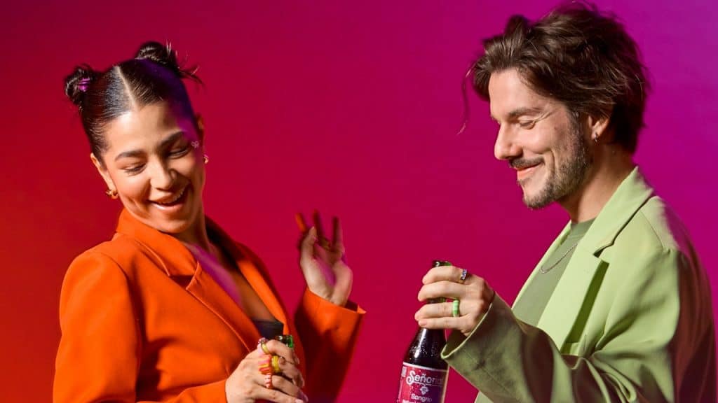 Two people enjoying drinks in vibrant colors.