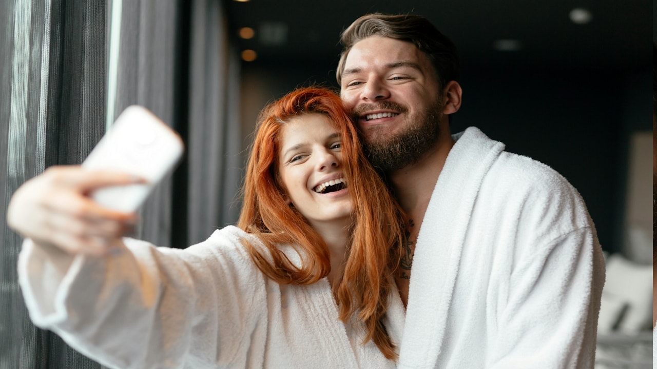 A couple in love enjoying a wellness weekend and taking selfies