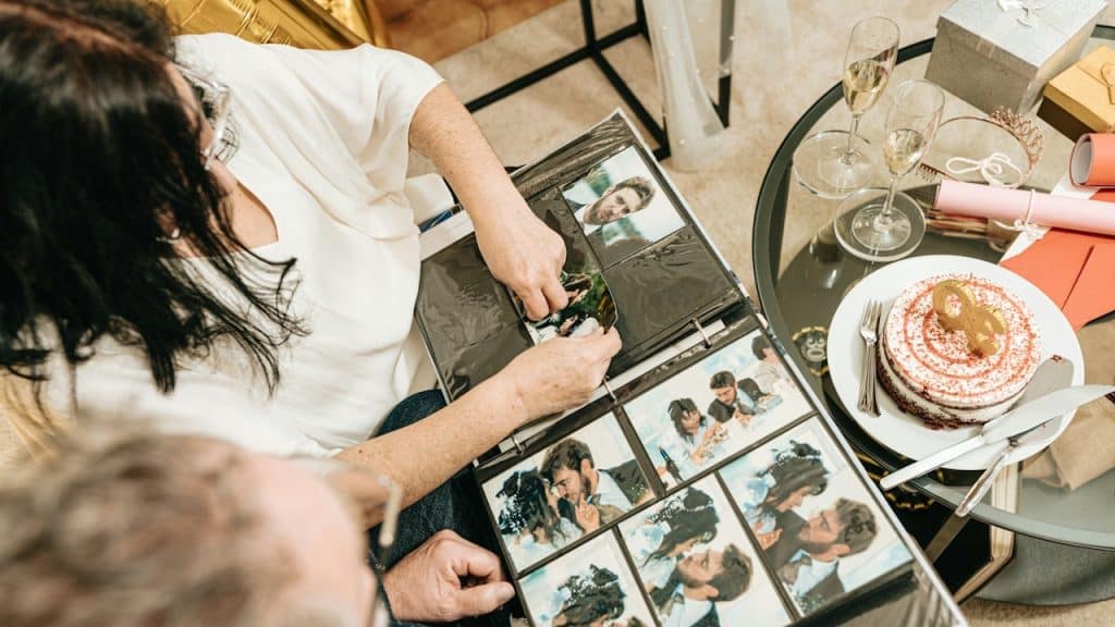 A couple revisiting their wedding album on their wedding anniversary.
