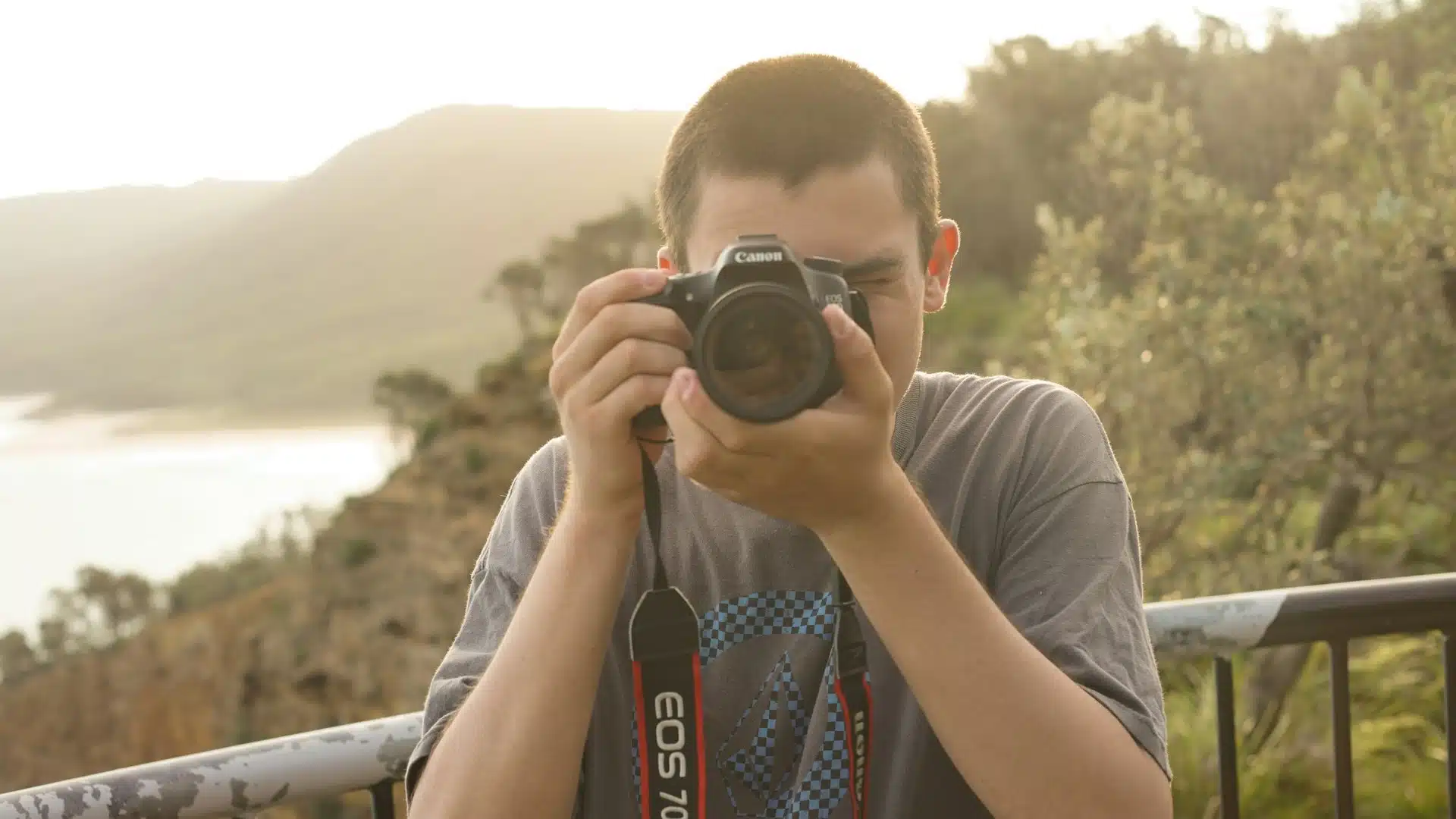 A man taking a photo with a DSLR camera.