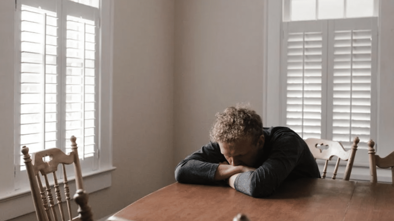 A man looking sad at home