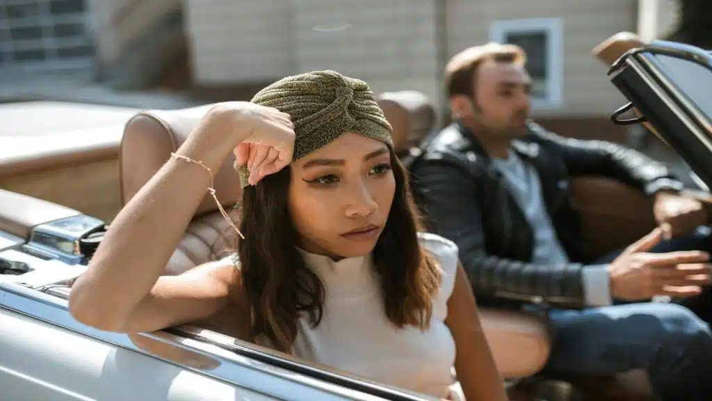 A woman ignoring her husband in the car