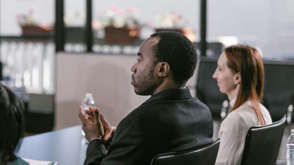 A man sitting and listening during a meeting.