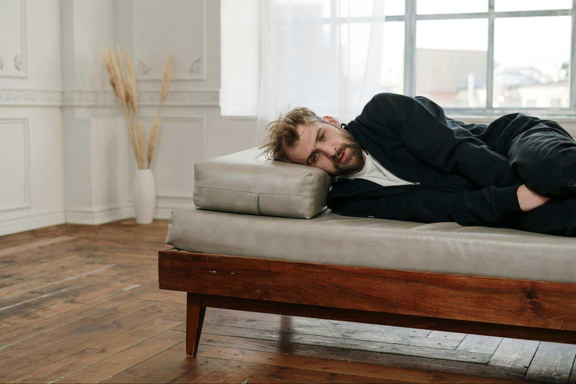 A man lying on a couch.