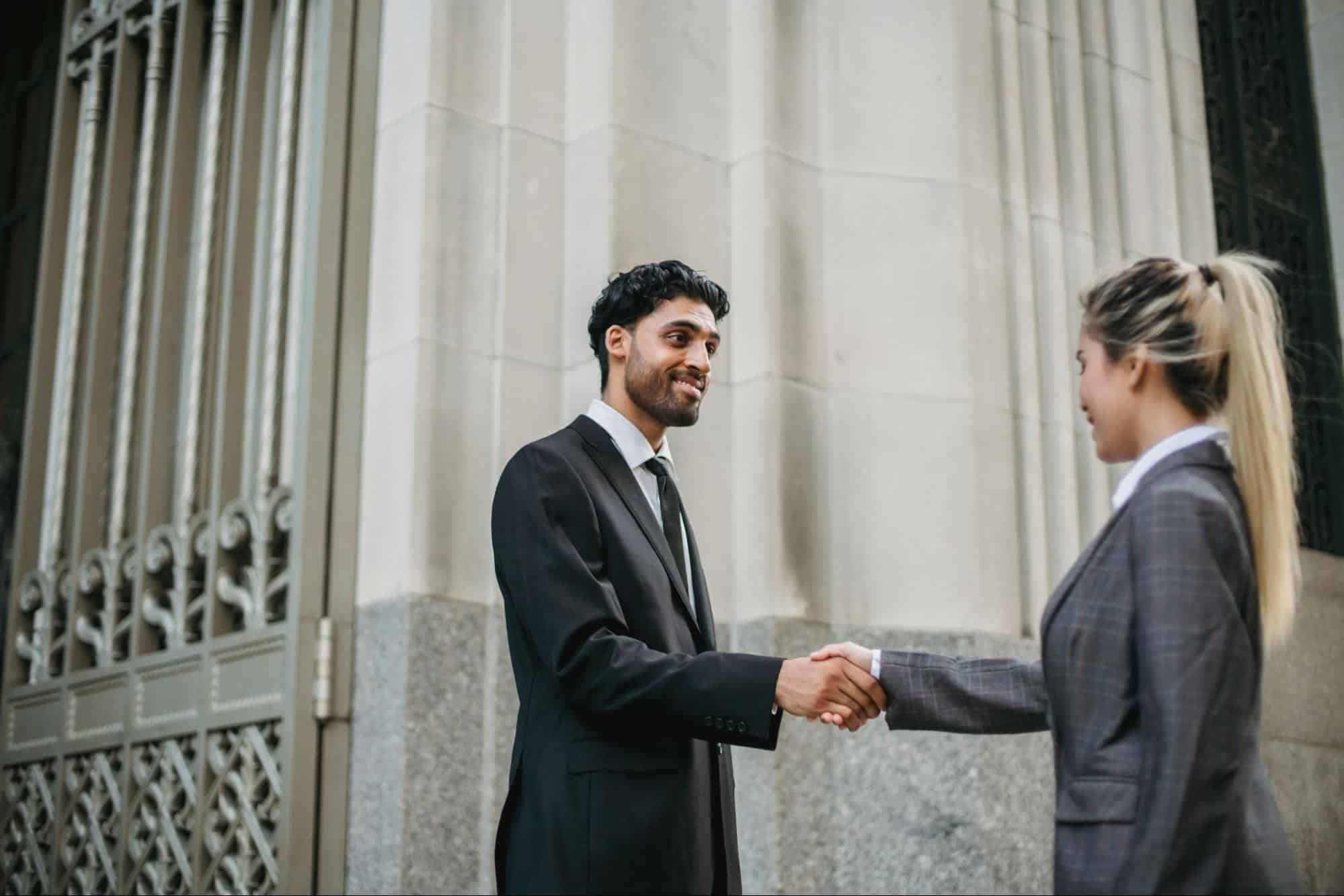 A man and woman shaking hands.