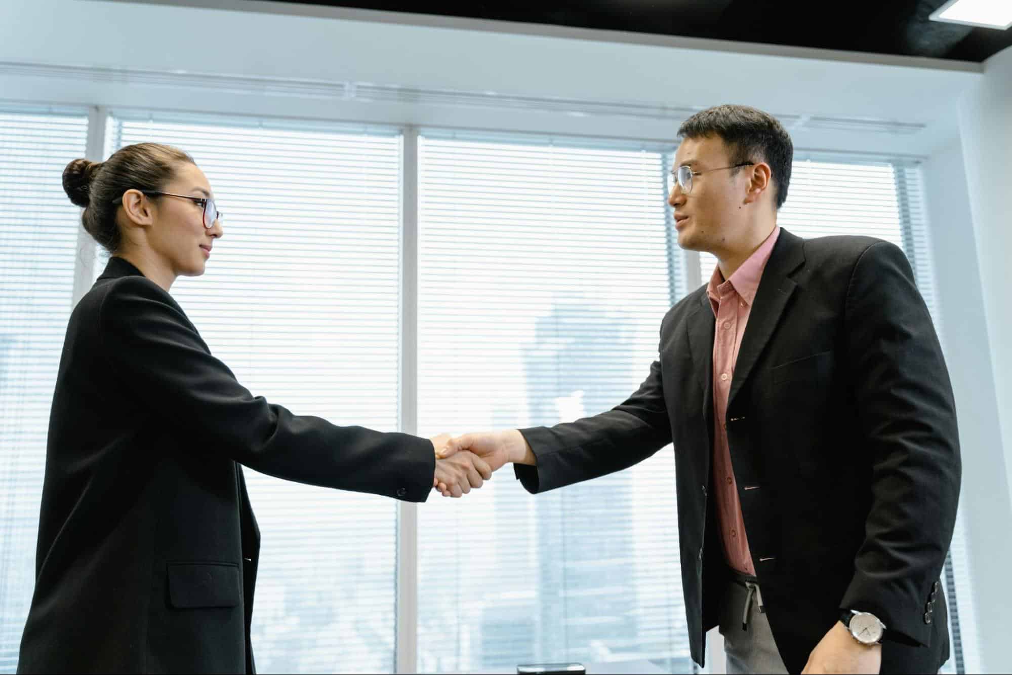 A man and woman shaking hands.