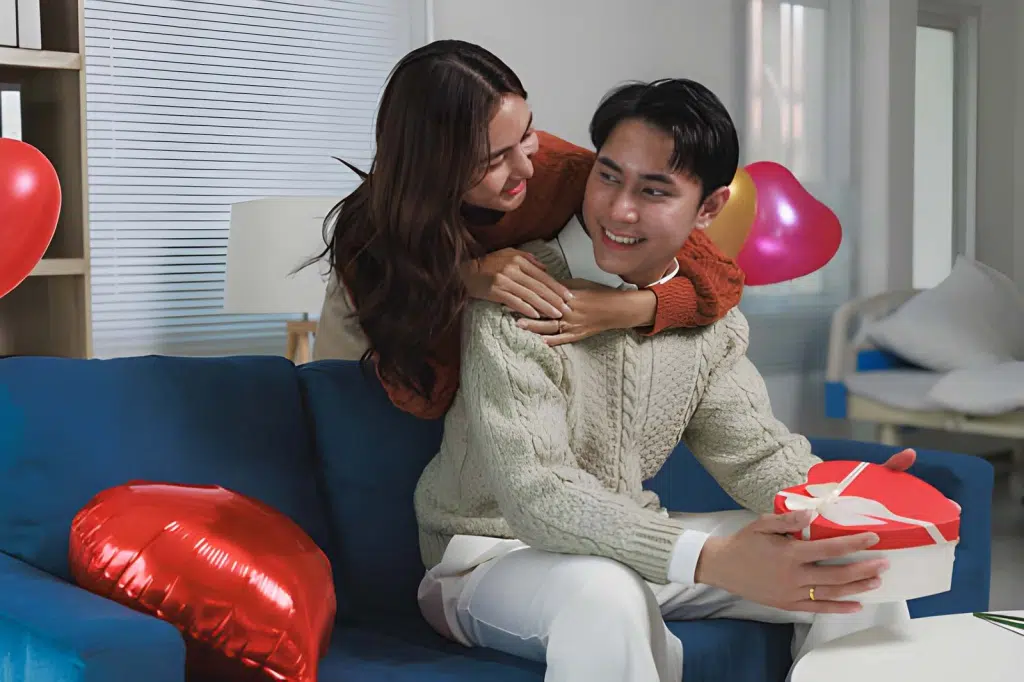 Wife giving husband heart shaped gift