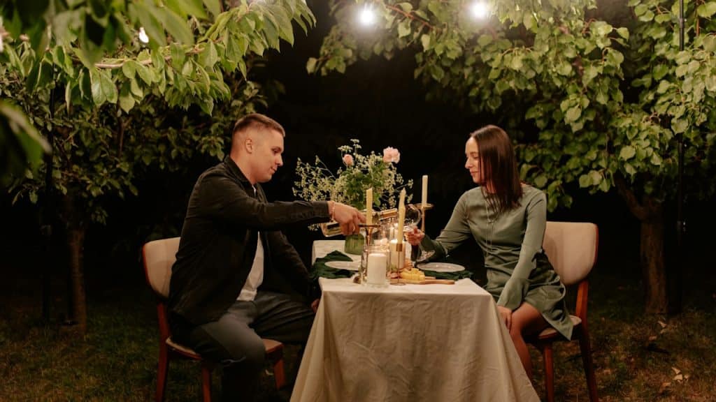 A man and a woman sitting at a dinner table.