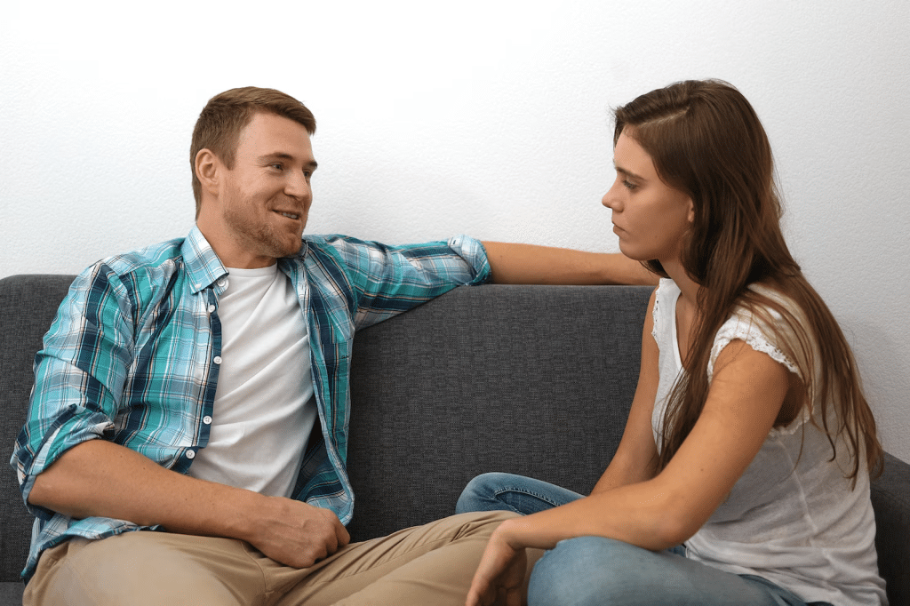 Woman looking serious while talking to a man