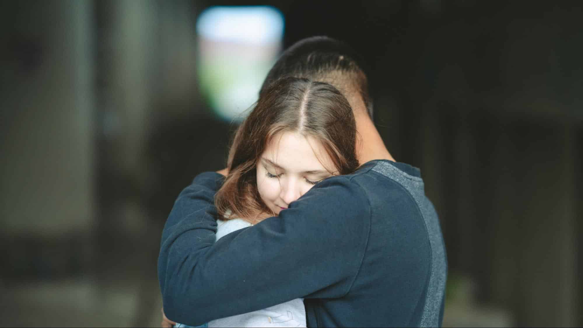 A man and woman hugging each other