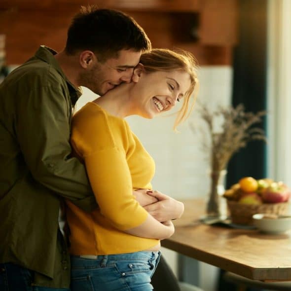A couple hugging in the kitchen