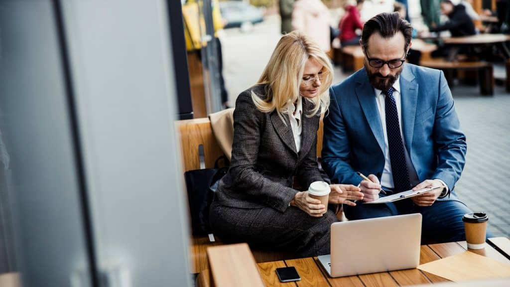 A man and a woman discussing a problem in an office.