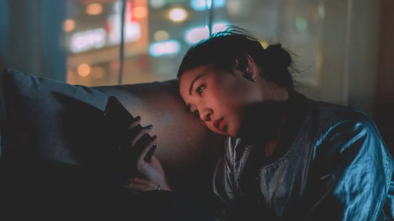 A woman waiting for a text