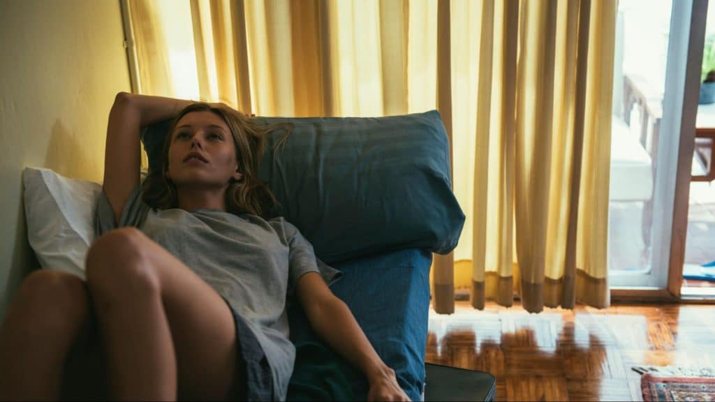 Woman thinking and lying on the sofa