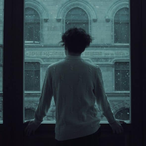 A man gazing out of a window.