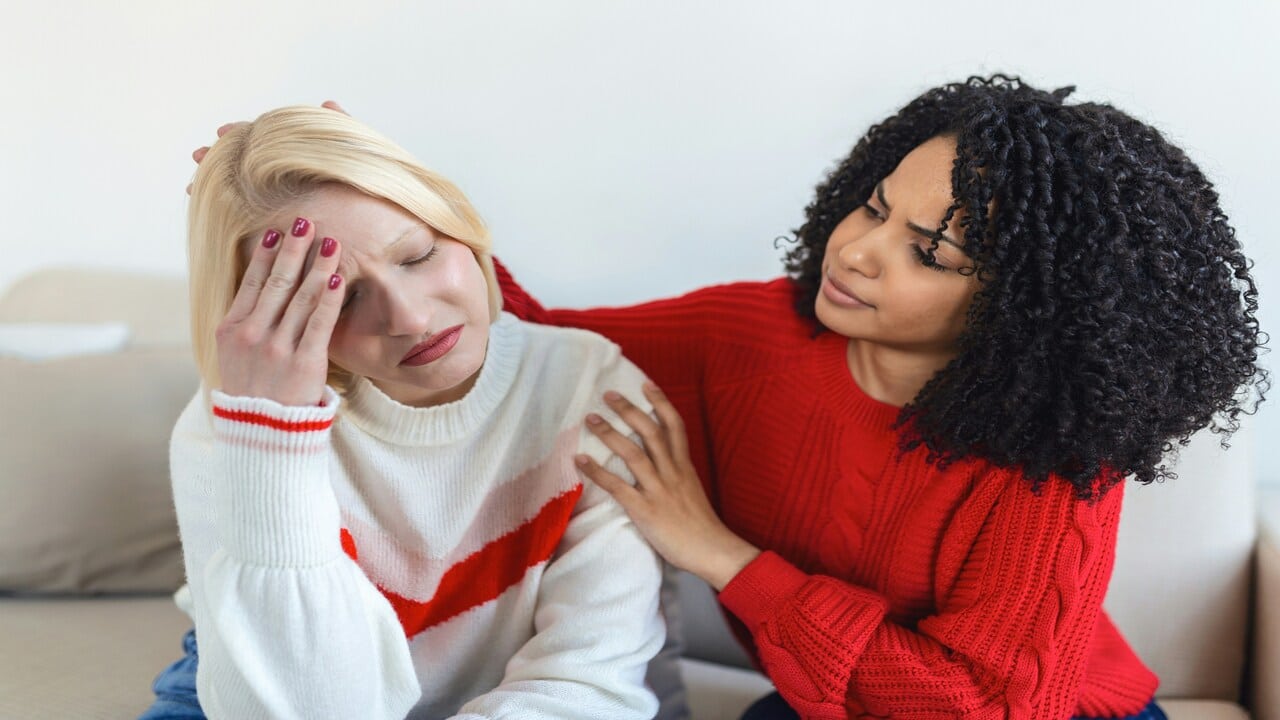 A woman comforting her crying friend
