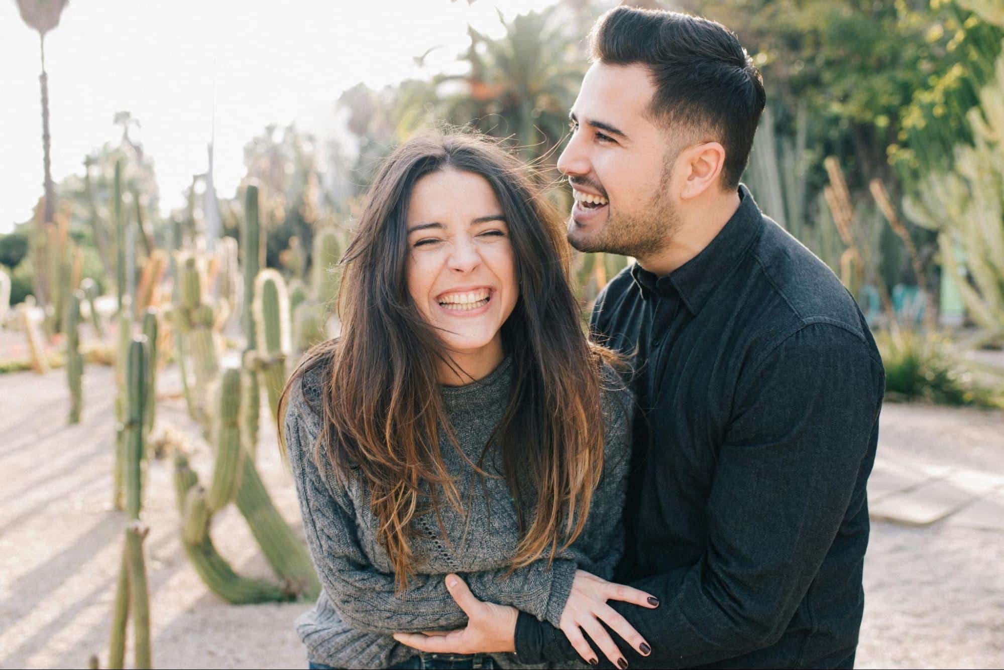 A couple hugging and laughing.