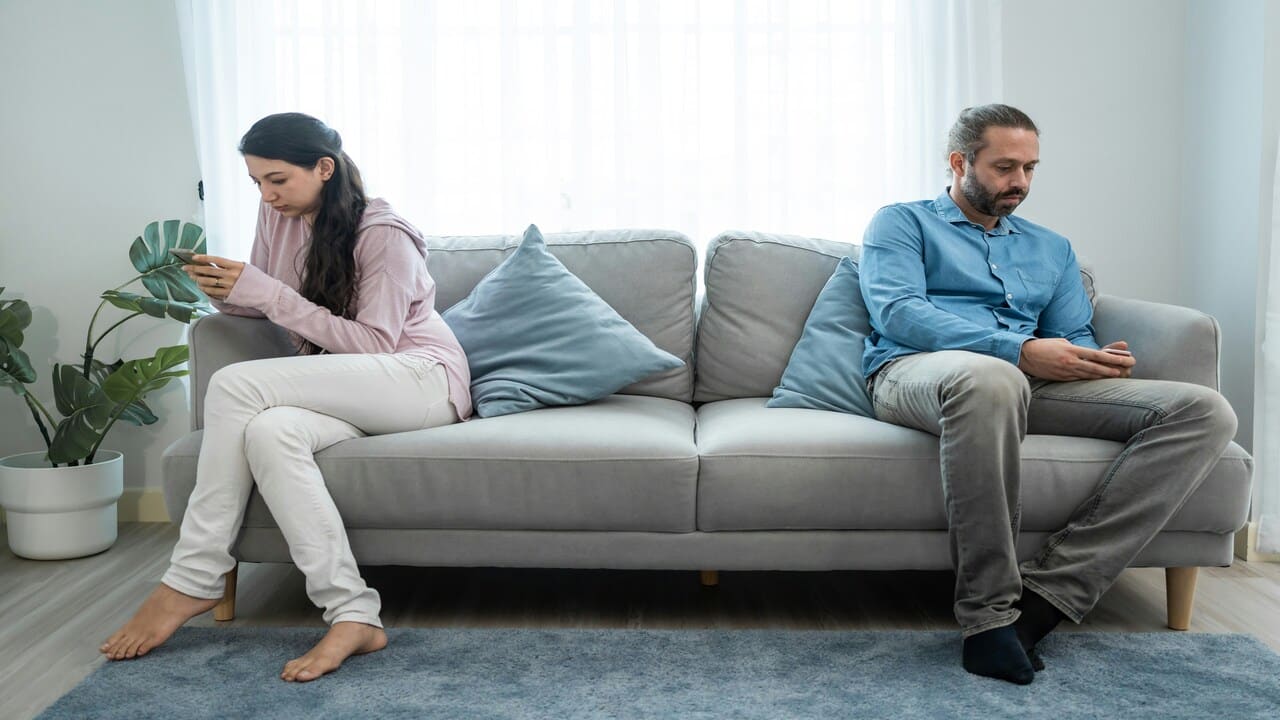 A couple busy with their phones