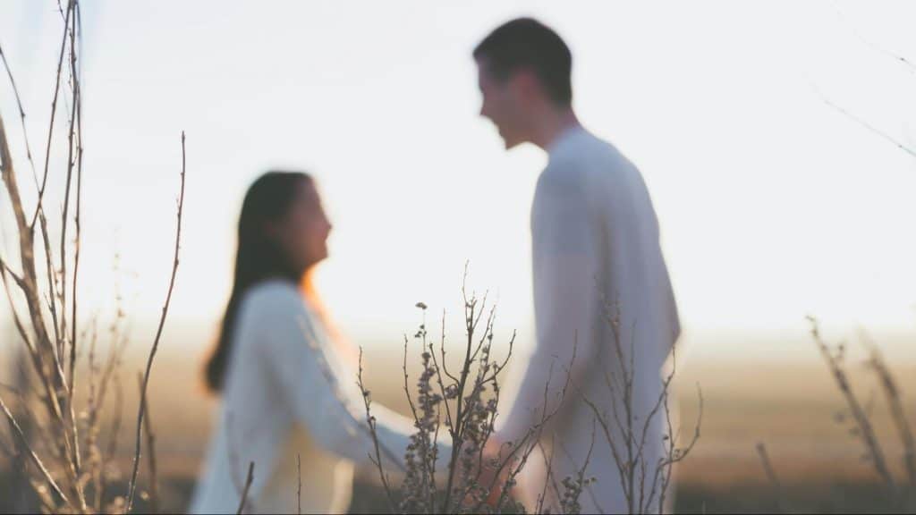 A blurry picture of couple holding hands