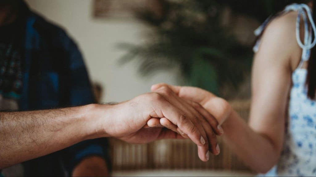 A man and woman holding hands