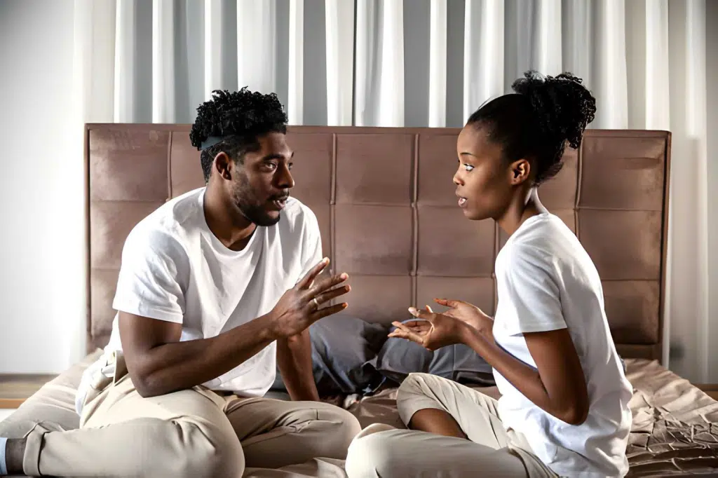 Couple having a serious discussion on bed