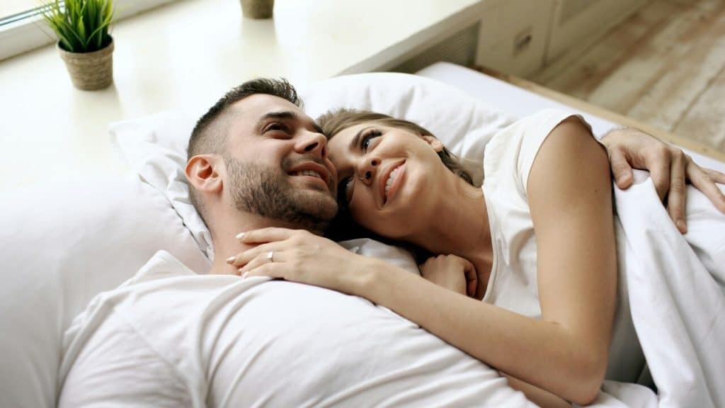 A couple cuddling at home together 