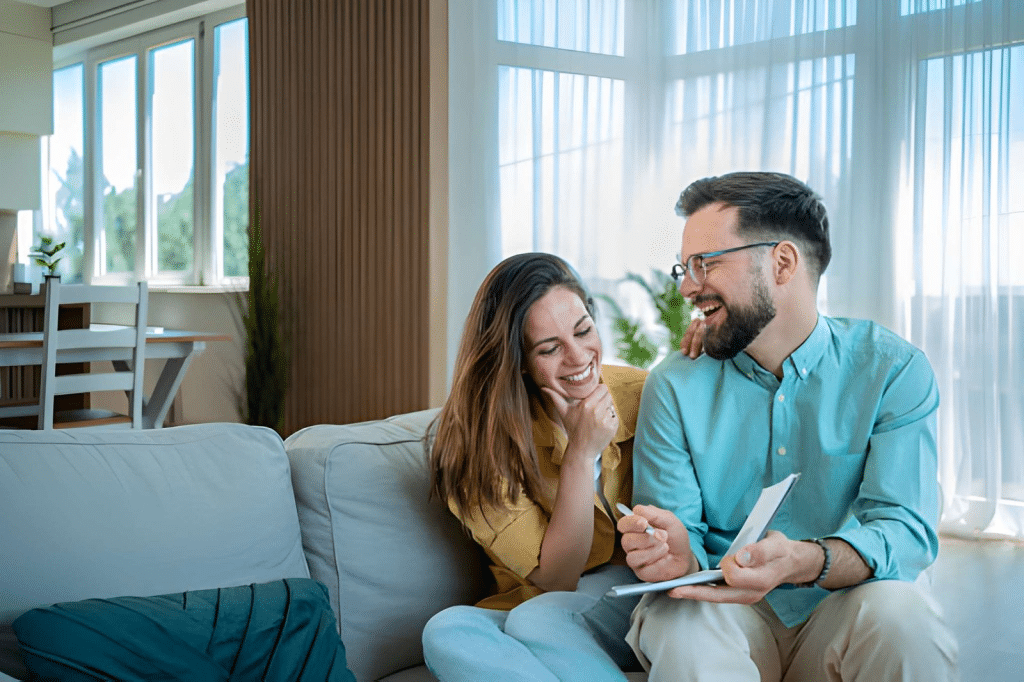 Couple laughing and discussing expenses