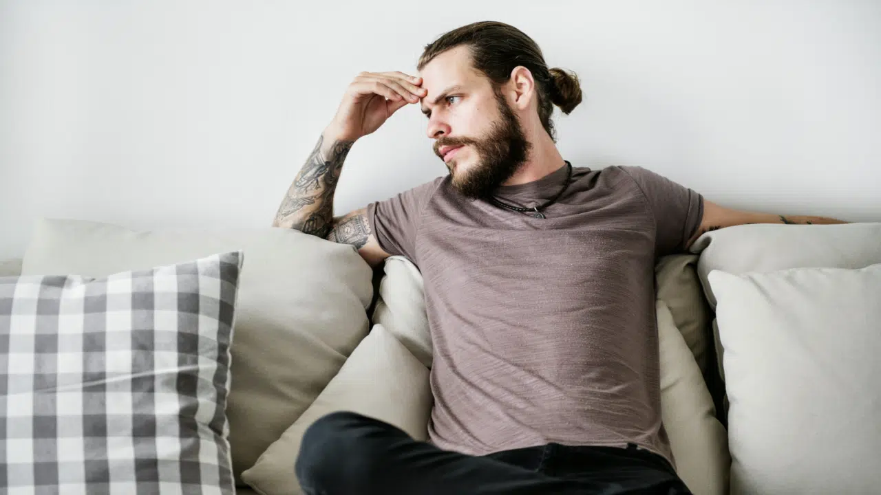 A man looking upset at home