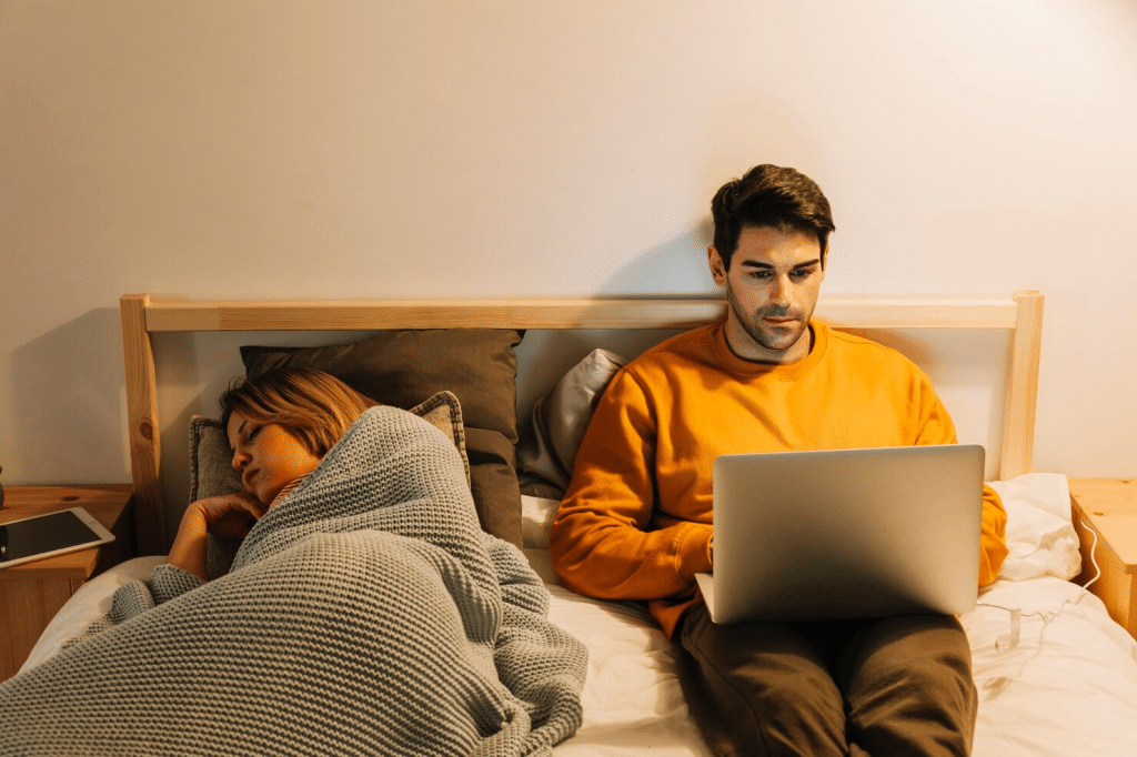 A man busy with work and a woman fell asleep