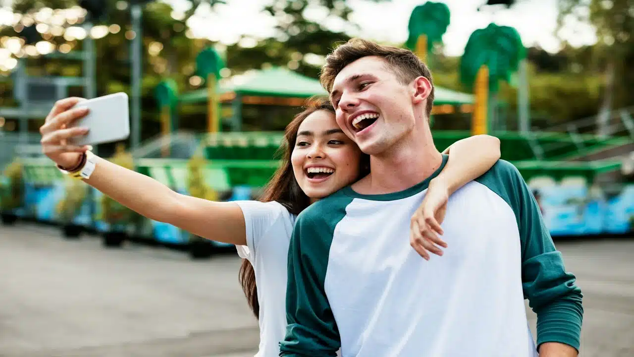 Young couple having fun together at an amusement park.