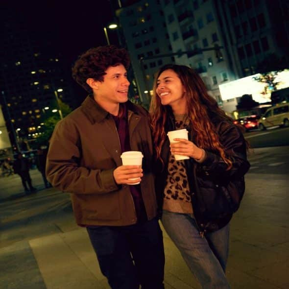 A couple drinking coffee at night
