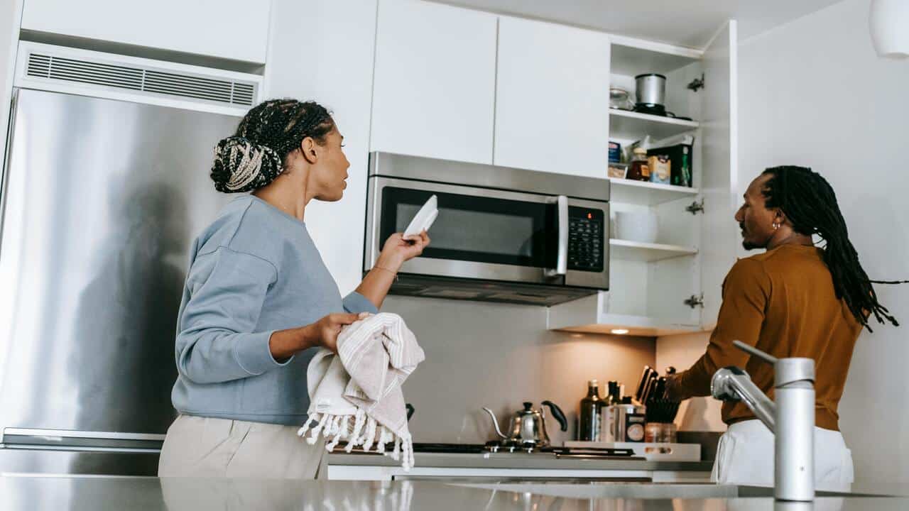 A couple fighting in the kitchen