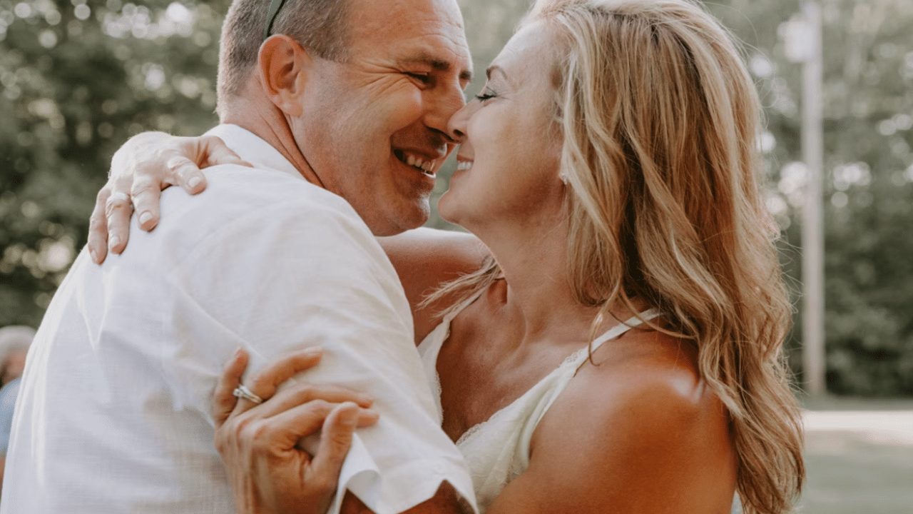 A mature couple kissing outdoors