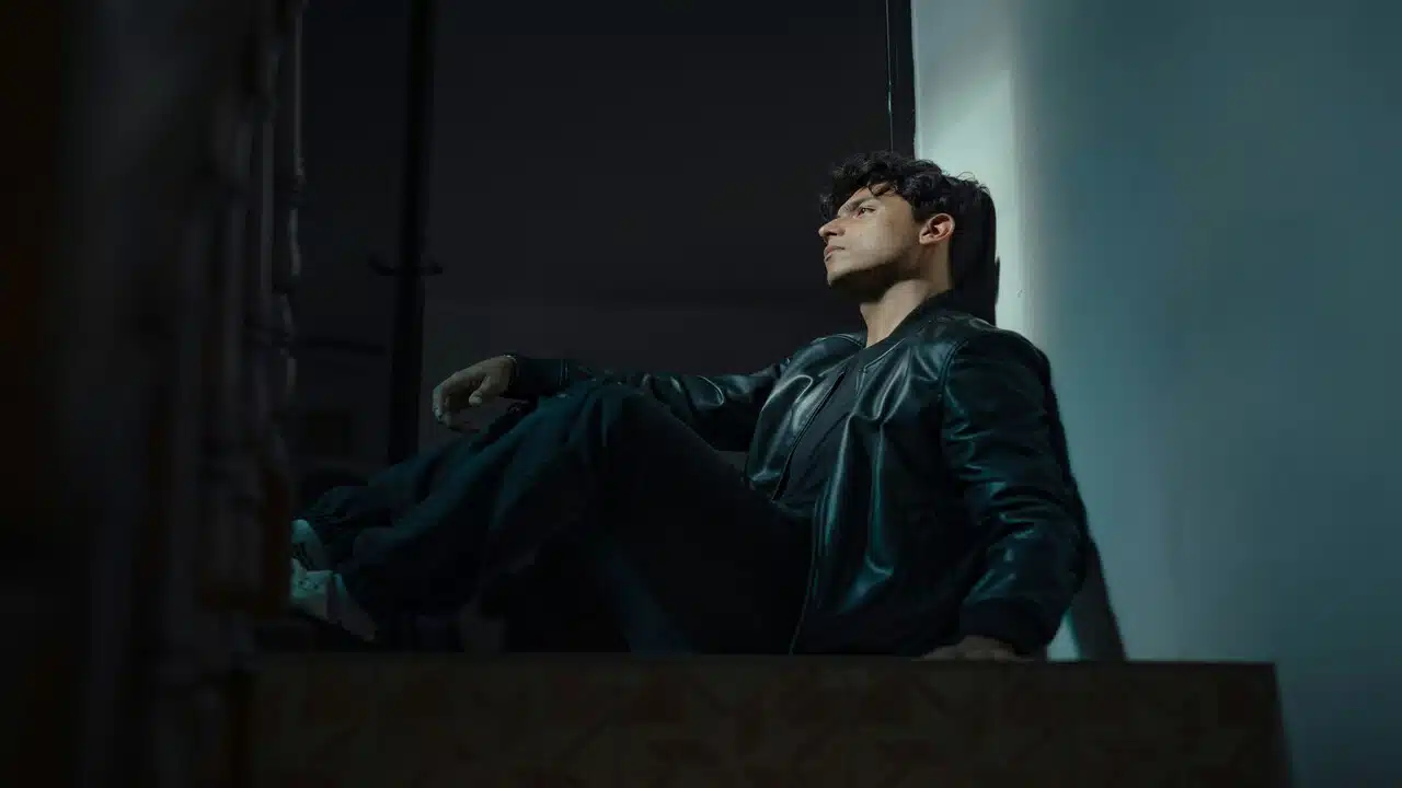 A man looking sad in a dark room