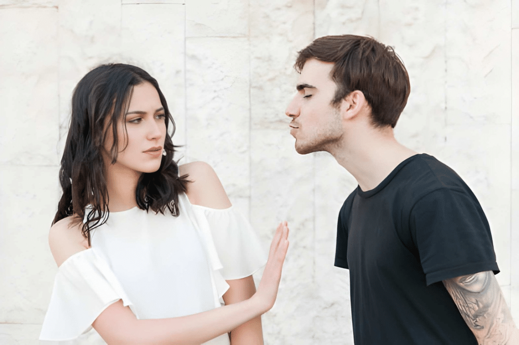 Woman rejecting kiss from man