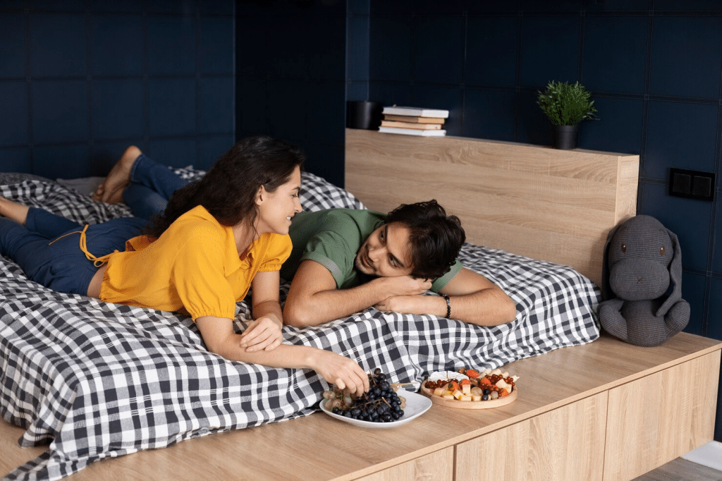 A man and woman at the bed