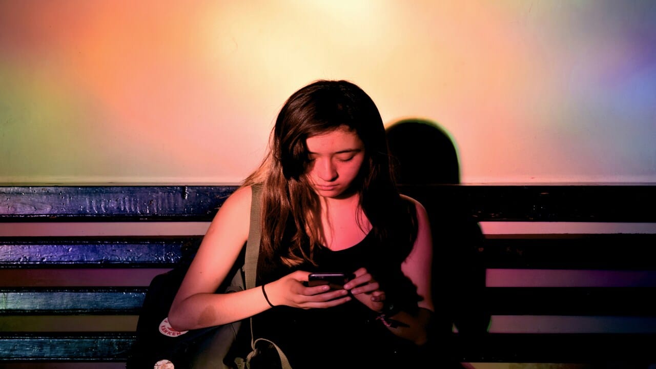 A woman looking sad while texting