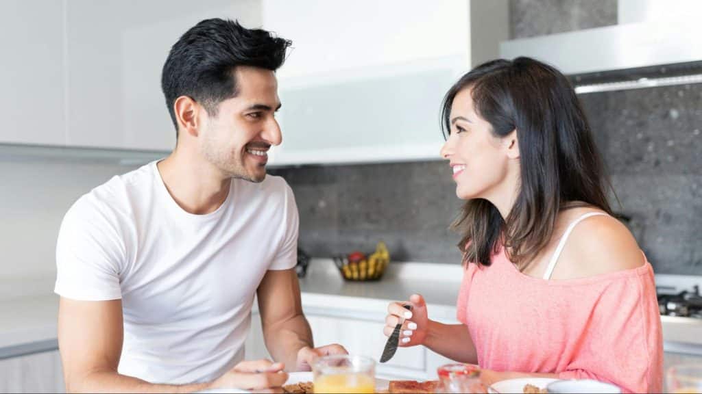 A man and woman smiling at each other