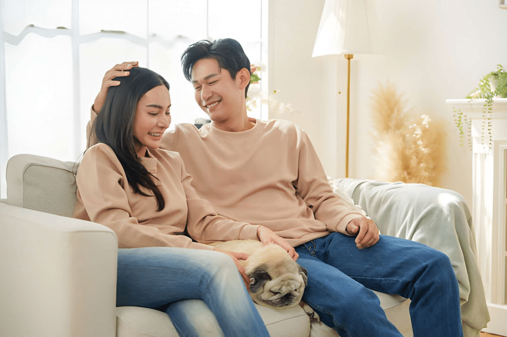 Man and woman enjoying quiet time at home on sofa