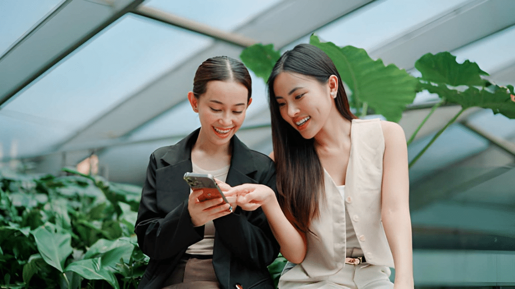 Two girls looking at phone smiling
