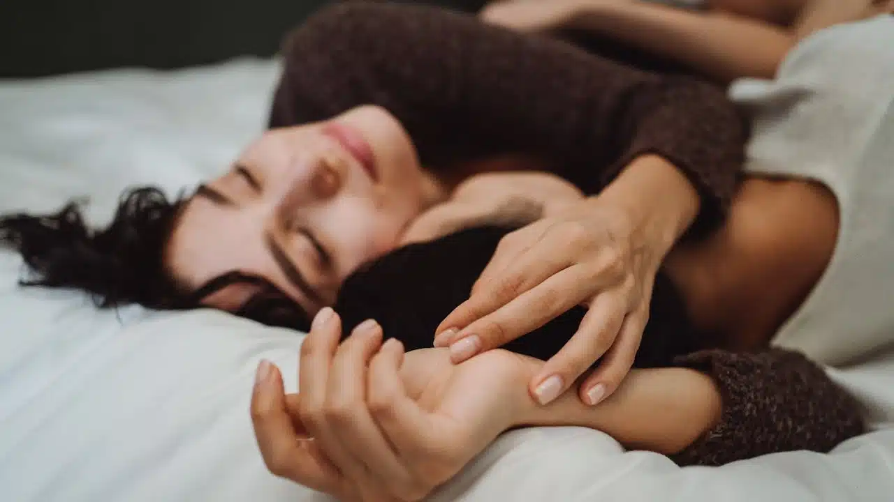 A couple hugging in bed